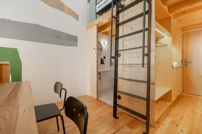a room with a wooden door and a table and chairs at Limehome Porto Rua da Conceicao in Porto