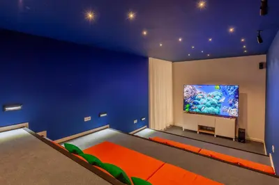 a blue room with a large screen tv on the wall at Savvy Signature Apartments in Porto
