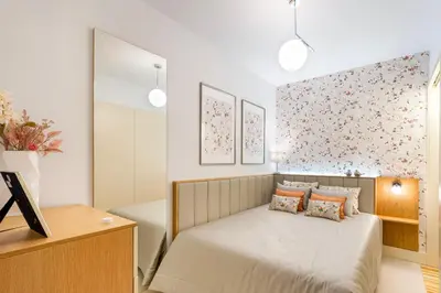 a bedroom with a bed and a wall with flowers at Stylish Poveiros Flat w Balcony by LovelyStay in Porto