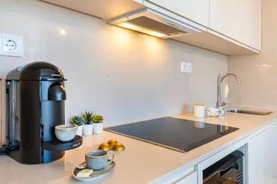 a kitchen with a coffee maker on a counter at Stylish Poveiros Flat w Balcony by LovelyStay in Porto