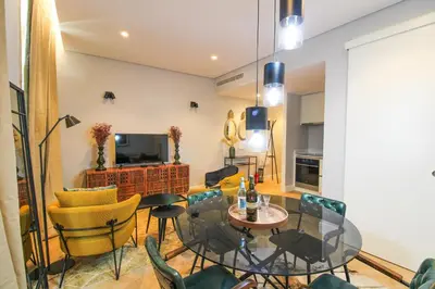 a living room with a table and chairs at Saudade do Porto in Porto