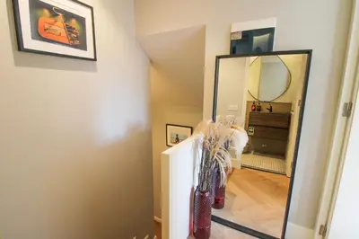 a hallway with a mirror and a dresser at Saudade do Porto in Porto
