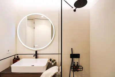 a bathroom with a white sink and a mirror at Dream Design Flat in Porto