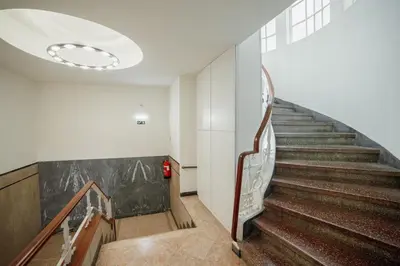 a hallway with stairs in a building with a ceiling at Rooftop Panoramic Batalha- PORTO in Porto