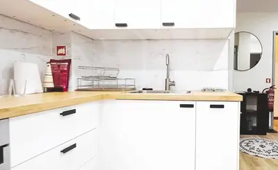 a kitchen with white cabinets and a sink at Lovling and Friendly with terrace in Porto