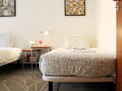 a bedroom with a bed and a table with a lamp at Lovling and Friendly with terrace in Porto