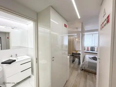 a white bathroom with a shower and a sink at ROSARIO 1Ds by rosario inn porto in Porto
