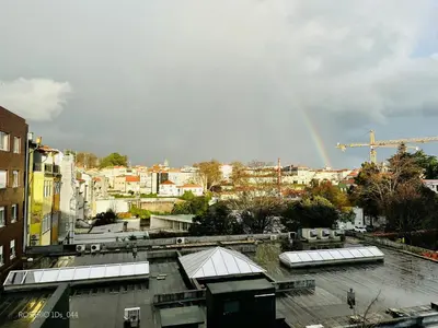 a view of a city with a rainbow in the sky at ROSARIO 1Ds by rosario inn porto in Porto