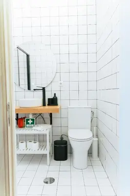 a white bathroom with a toilet and a sink at Cedofeita studio 41 in Porto