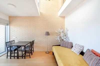 a living room with a couch and a table at VIVA Stadium Residence Studios in Porto