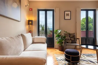 a living room with a couch and a table at Elegant Duplex Apt in Downtown by Lisbeyond in Porto