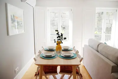 a living room with a table and a couch at Almada Prime - Live in Porto in Porto