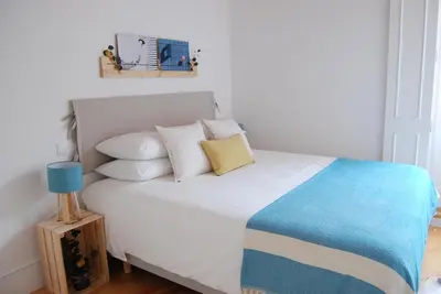a bedroom with a bed with white sheets and pillows at Almada Prime - Live in Porto in Porto