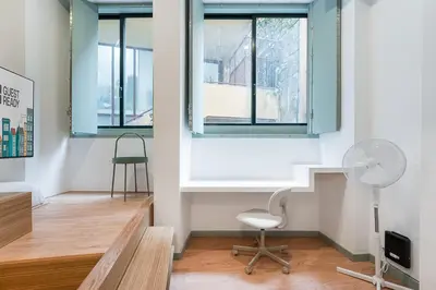 a living room with a chair and a window at GuestReady - A modern stay in Downtown in Porto