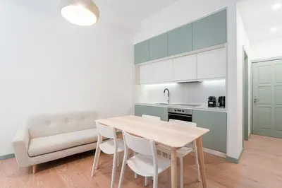 a kitchen and dining room with a table and chairs at GuestReady - A modern stay in Downtown in Porto