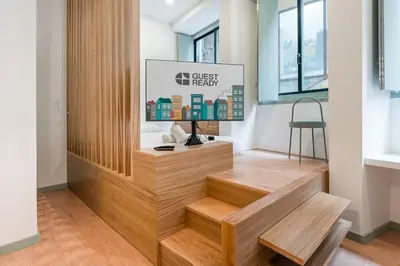 a lobby with wooden steps and a sign on the wall at GuestReady - A modern stay in Downtown in Porto