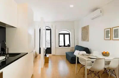 a kitchen and living room with a table and chairs at Fernandes Tomas Rooftop in Porto
