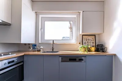 a kitchen with a sink and a window at Nomad's Easy Stay - Studio Lounge Casa da Musica in Porto