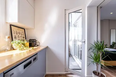 a kitchen with a counter and a window at Nomad's Easy Stay - Studio Lounge Casa da Musica in Porto