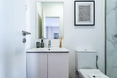 a white bathroom with a sink and a toilet at Nomad's Easy Stay - Studio Lounge Casa da Musica in Porto