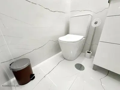 a white bathroom with a toilet and a trash can at ROSARIO 1Dn by rosario inn porto in Porto