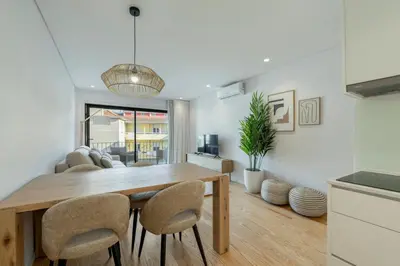 a kitchen and dining room with a wooden table and chairs at GuestReady - Comfortable stay in Porto in Porto