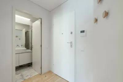 a white bathroom with a sink and a mirror at GuestReady - Comfortable stay in Porto in Porto