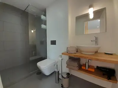 a bathroom with a sink and a toilet and a shower at Vista Bolhão Studio in Porto