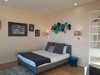 a bedroom with a bed with balloons on the wall at Vista Bolhão Studio in Porto