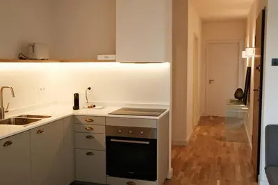 a kitchen with a sink and a stove top oven at Corujeira Apartments by MyALPlace in Porto