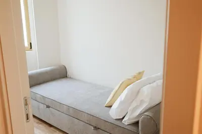 a couch in a room with a bed in it at Corujeira Apartments by MyALPlace in Porto