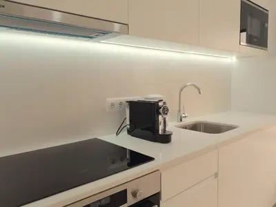 a white kitchen with a sink and a sink at VB Porto Studio II in Porto