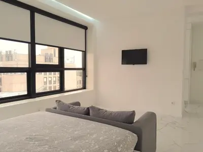 a bedroom with a bed and a tv on the wall at VB Porto Studio II in Porto