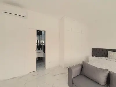 a white bedroom with a bed and a couch at VB Porto Studio II in Porto