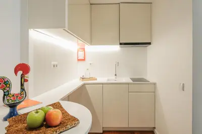 a kitchen with a table with fruit on it at Bandeiras in Porto