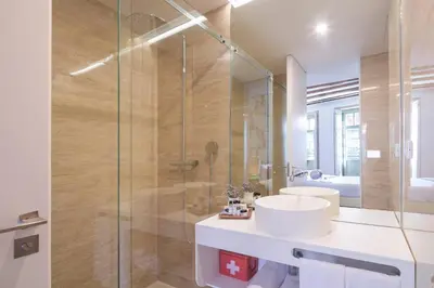 a bathroom with a sink and a glass shower at Bandeiras in Porto