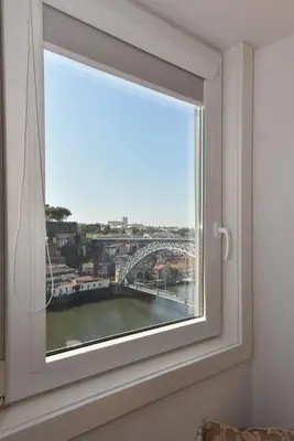 a window with a view of a bridge at Miradouro 25 - Porto centre - luxury epic views in Porto