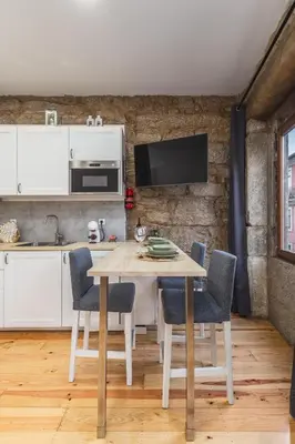 a kitchen and dining room with a table and chairs at Charming Studio with Garden in Porto in Porto
