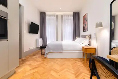 a hotel room with a bed and a television at Limehome Porto Rua 31 de Janeiro in Porto