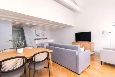 a living room with a couch and a table at Limehome Porto Rua 31 de Janeiro in Porto