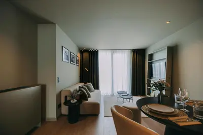 a living room with a table and a living room with a couch at Hotels 705 Porto Prime Home in Porto