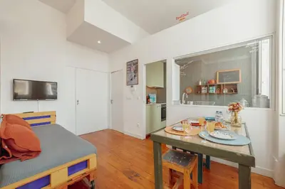 a living room with a table and a dining room at Downtown Bolhão by Hosty in Porto