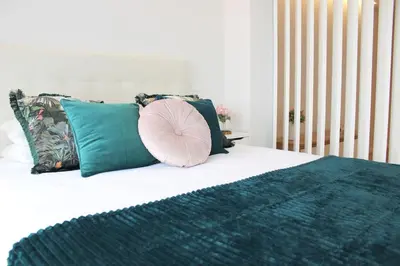 a pillow sitting on top of a bed with pillows at Marquês City Center Flat in Porto