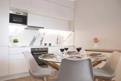 a kitchen with a table with glasses of wine at Marquês City Center Flat in Porto