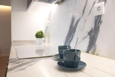 two coffee cups sitting on a counter in a room at Marquês City Center Flat in Porto