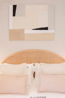 a bed with white pillows and a painting on the wall at Liiiving in Porto - Luxury Design Apartments in Porto