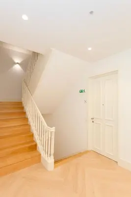 an empty room with stairs and a white door at Liiiving in Porto - Luxury Design Apartments in Porto