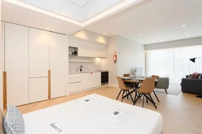 a bedroom with a bed and a table with chairs at Liiiving in Porto - Luxury Design Apartments in Porto