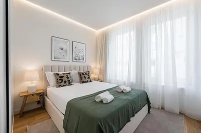 a bedroom with a bed with two towels on it at GuestReady - Little Johnny in Porto