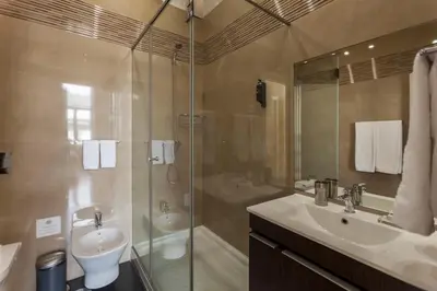 a bathroom with a shower and a sink and a toilet at BO - Fernandes Tomás in Porto